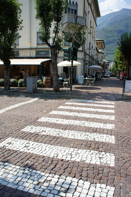 ティラーノの横断歩道。道路はアスファルトではなく石畳。石畳の上に横断歩道がペイントされている。 右側の写真は駅の中。ここにも箱根登山鉄道寄贈